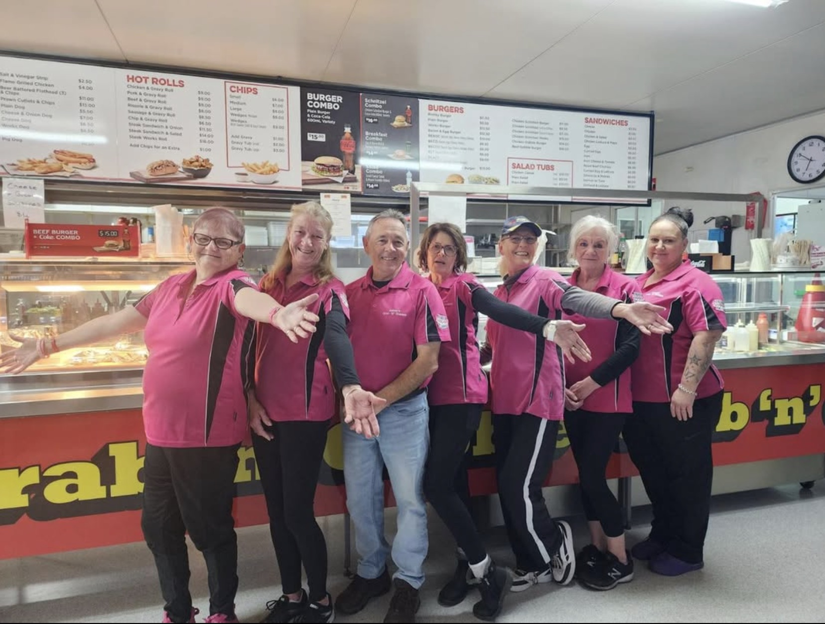 Takeaway shop team all wearing pink