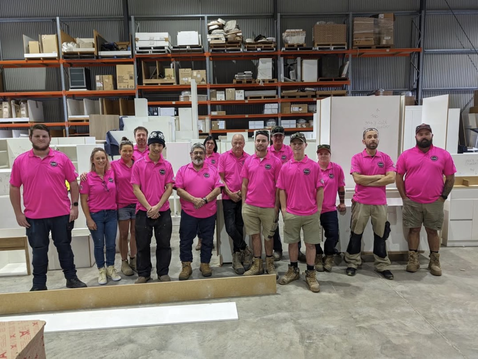 Workshop crew in pink shirts on the job
