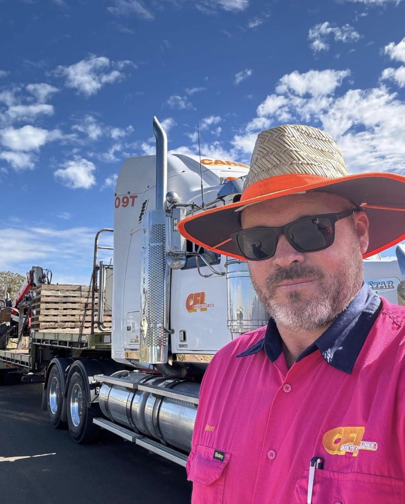 Truckie in pink shirt with his rig
