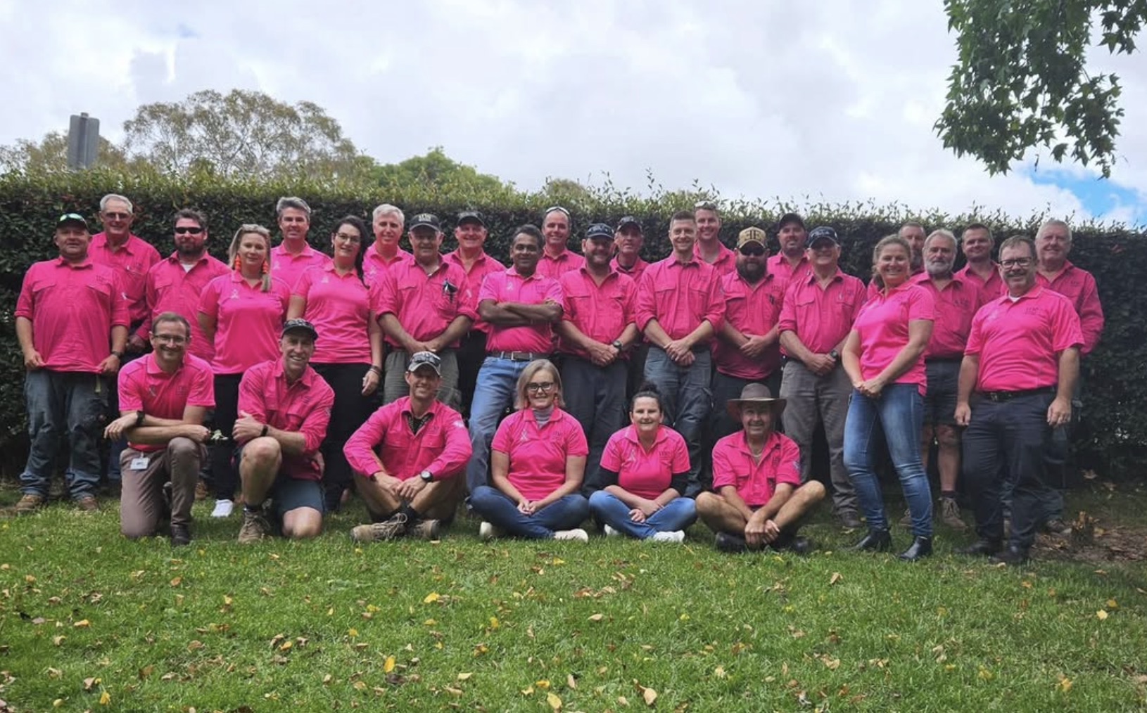 Large group of supporters all wearing pink shirts