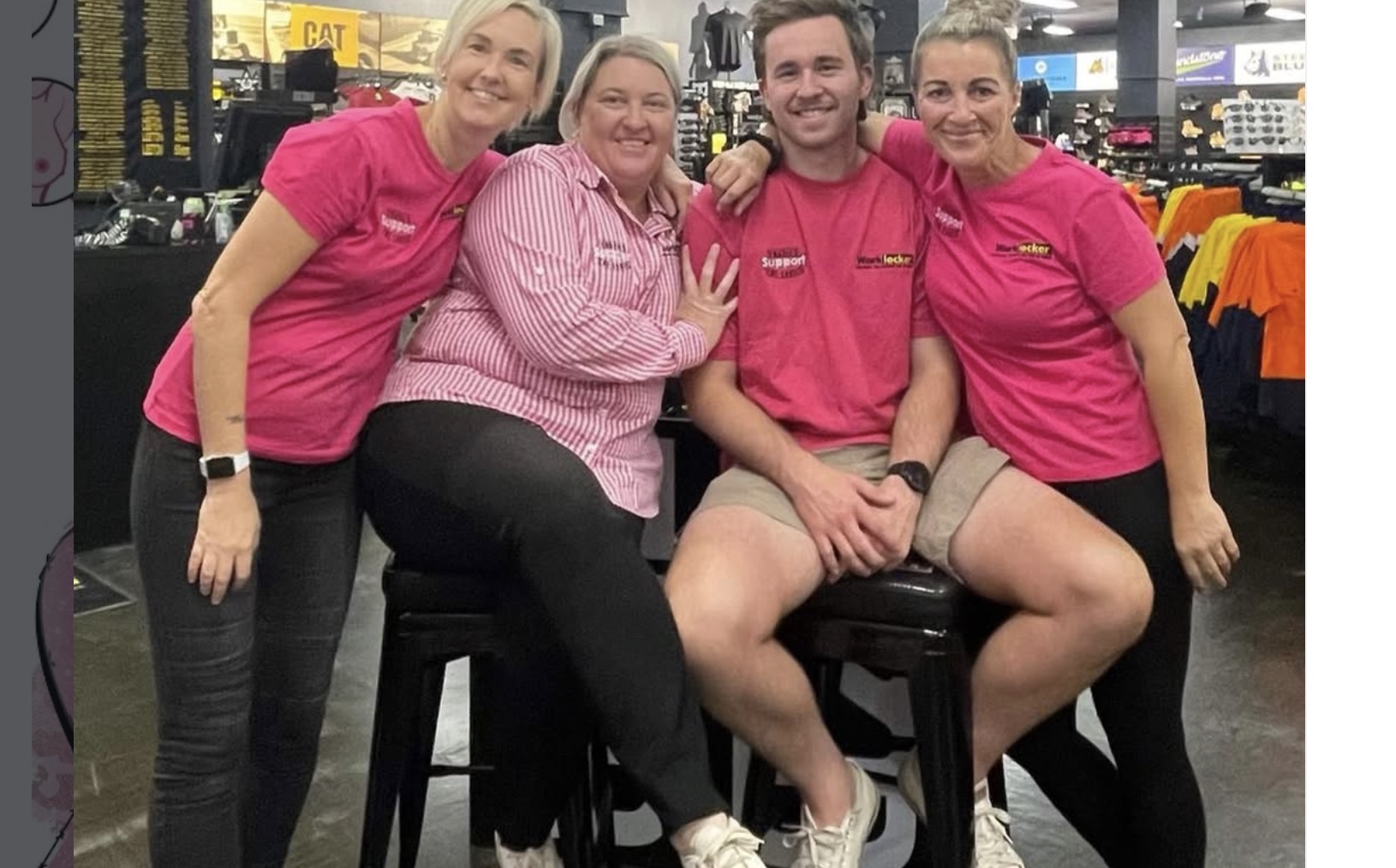 Four supporters in pink at a workwear store