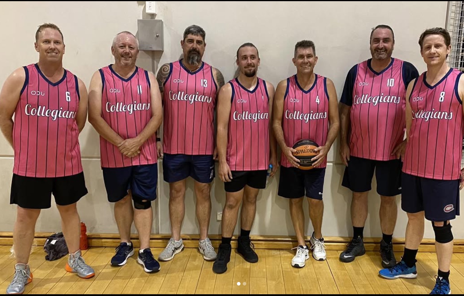 Basketball team in pink Collegians jerseys