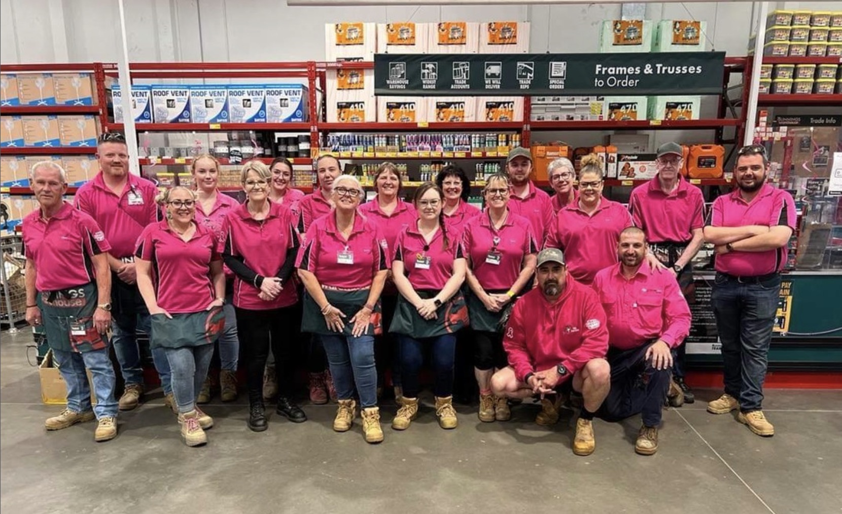 Large hardware store team all wearing pink
