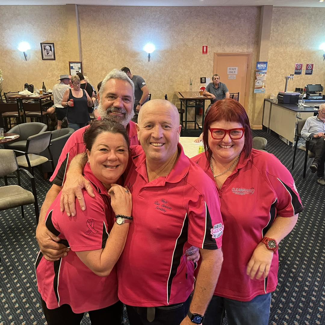 Four supporters in pink shirts at a fundraising event